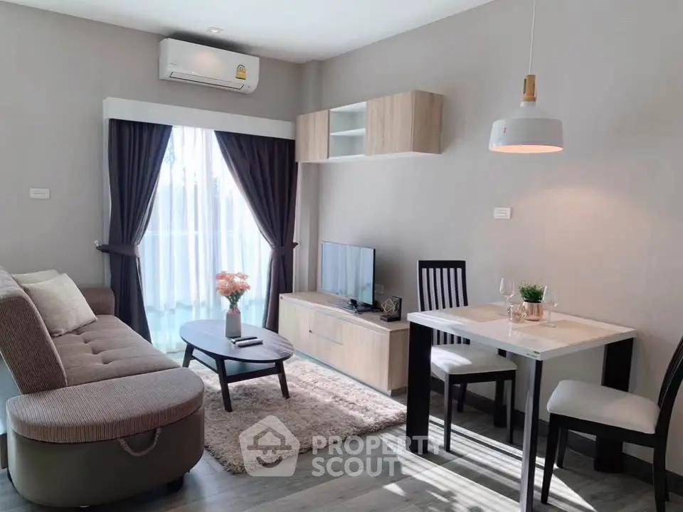 Modern living room with cozy sofa, dining area, and natural light