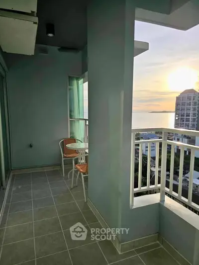 Stunning balcony with ocean view and sunrise, perfect for relaxation.
