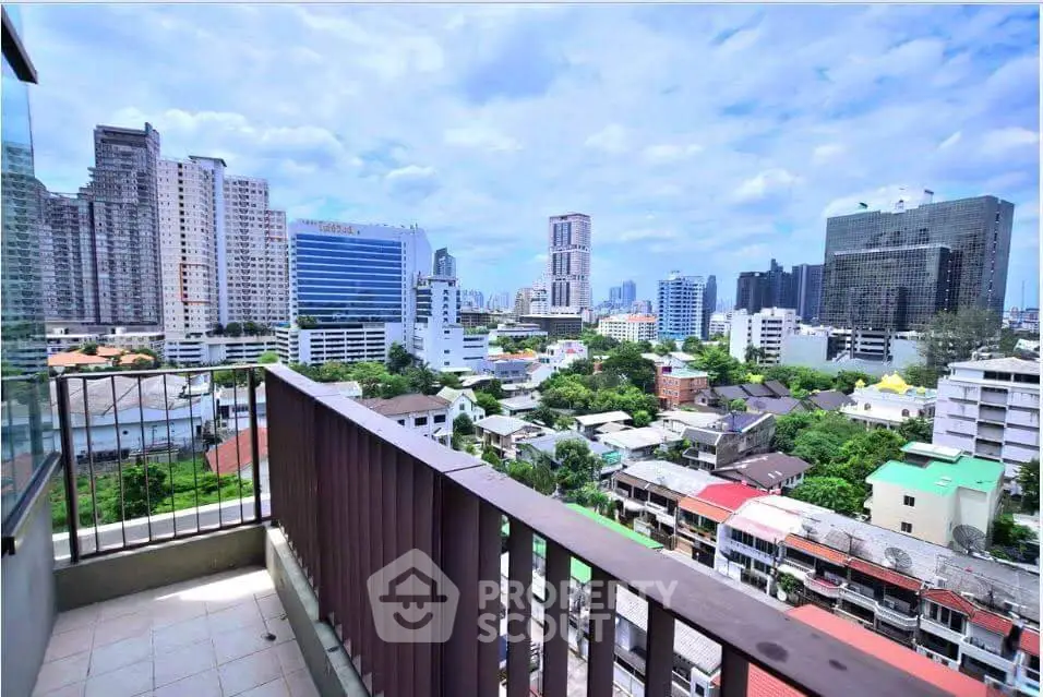 Stunning cityscape view from a high-rise balcony in urban setting.