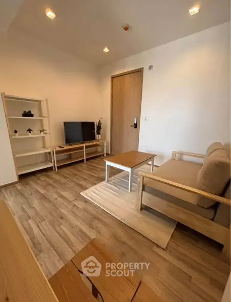 Modern living room with minimalist furniture and wooden flooring