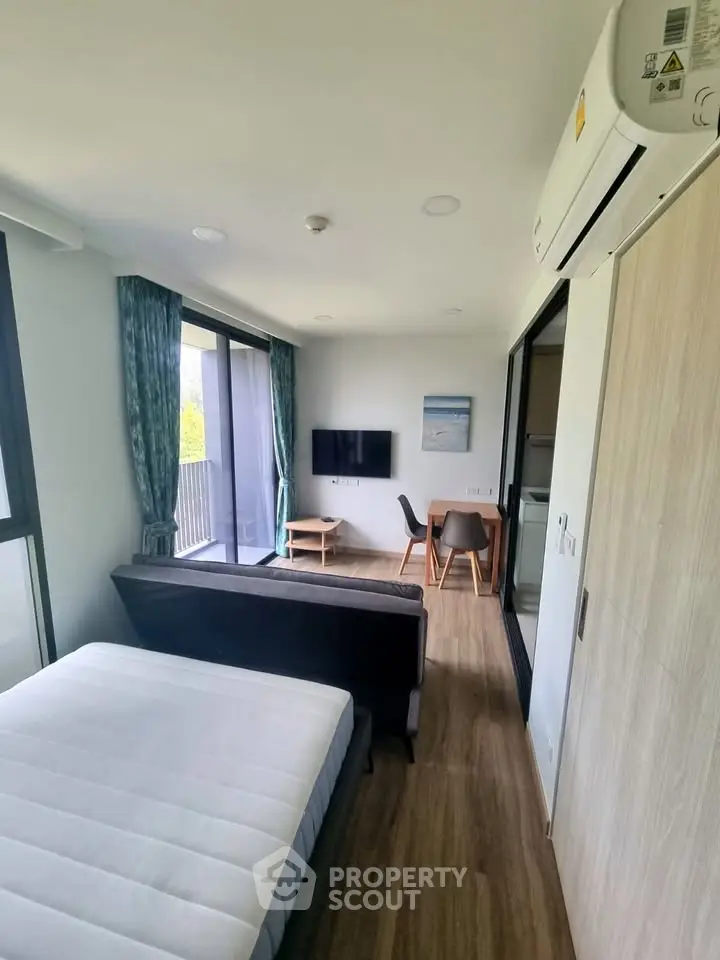 Modern studio apartment with sleek furnishings and natural light