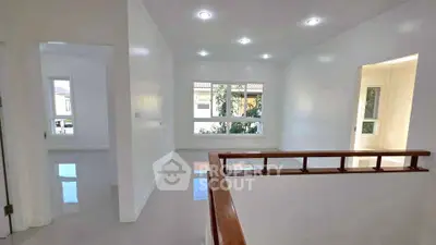 Bright and spacious interior with large windows and modern lighting, perfect for a cozy living area.