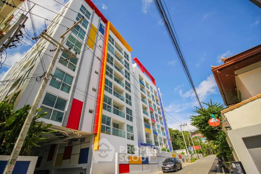 Modern colorful apartment building with vibrant facade and clear blue sky