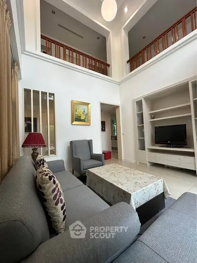 Spacious living room with high ceiling and elegant decor in modern home
