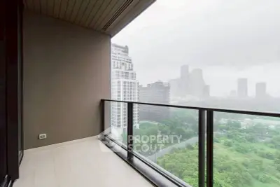 Spacious balcony with stunning cityscape view in modern high-rise apartment.