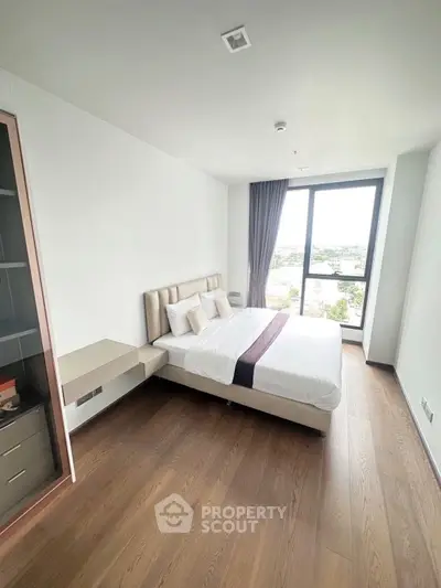 Modern bedroom with large window and stylish decor in a bright apartment