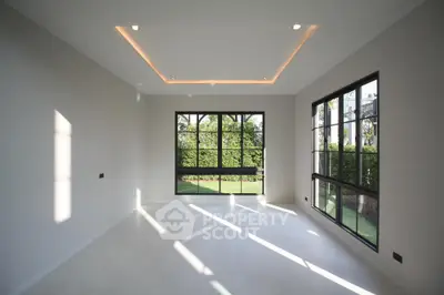 Spacious modern living room with large windows and garden view