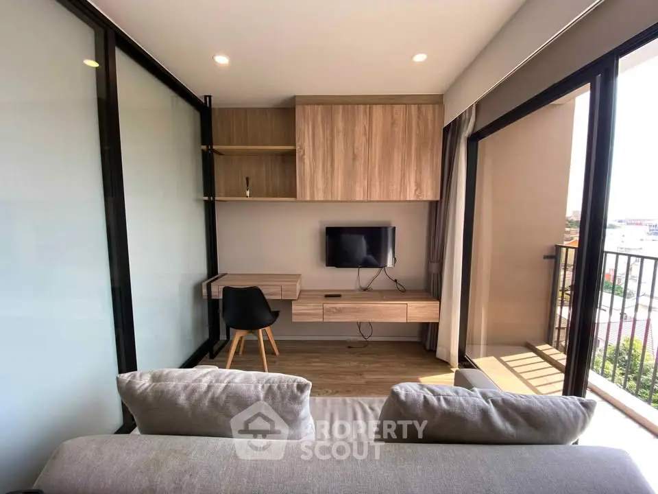 Modern living room with balcony view and sleek furniture design