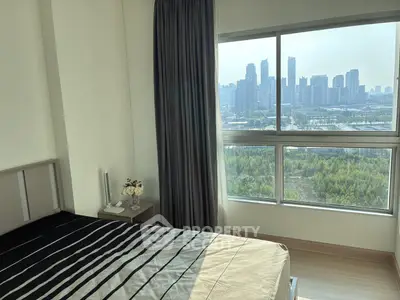 Modern bedroom with city skyline view, featuring large windows and stylish decor.