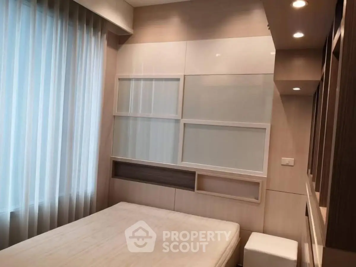 Modern bedroom with stylish wall design and soft lighting, perfect for a cozy retreat.