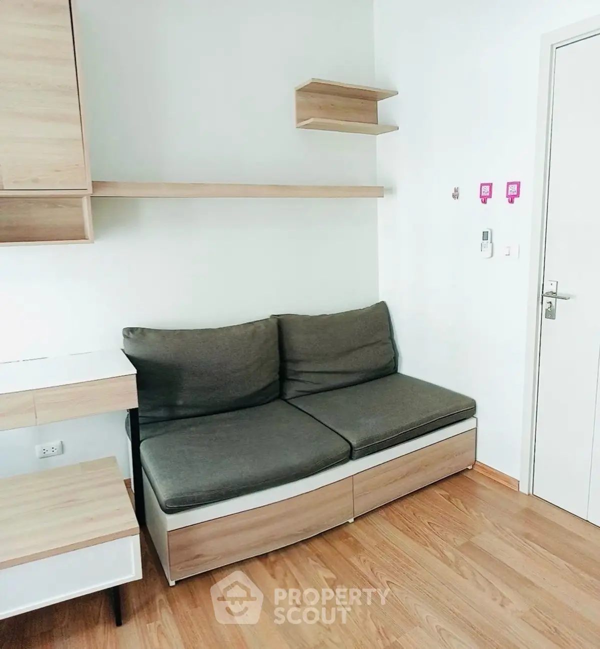 Modern minimalist living room with sleek wooden furniture and cozy sofa