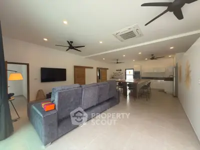 Spacious modern living room with open kitchen and sleek furnishings