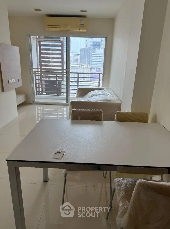 Modern apartment with balcony view and sleek dining area