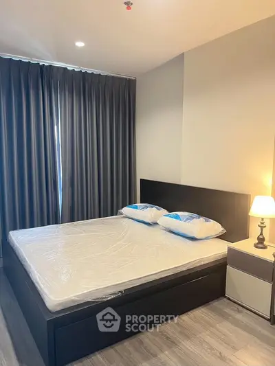 Modern bedroom with sleek design and cozy ambiance, featuring a comfortable bed and stylish decor.