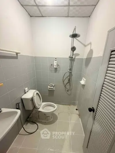 Compact bathroom with shower and toilet in minimalist design