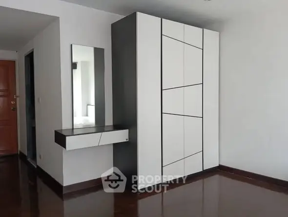 Modern minimalist interior with sleek wardrobe and mirror in stylish apartment