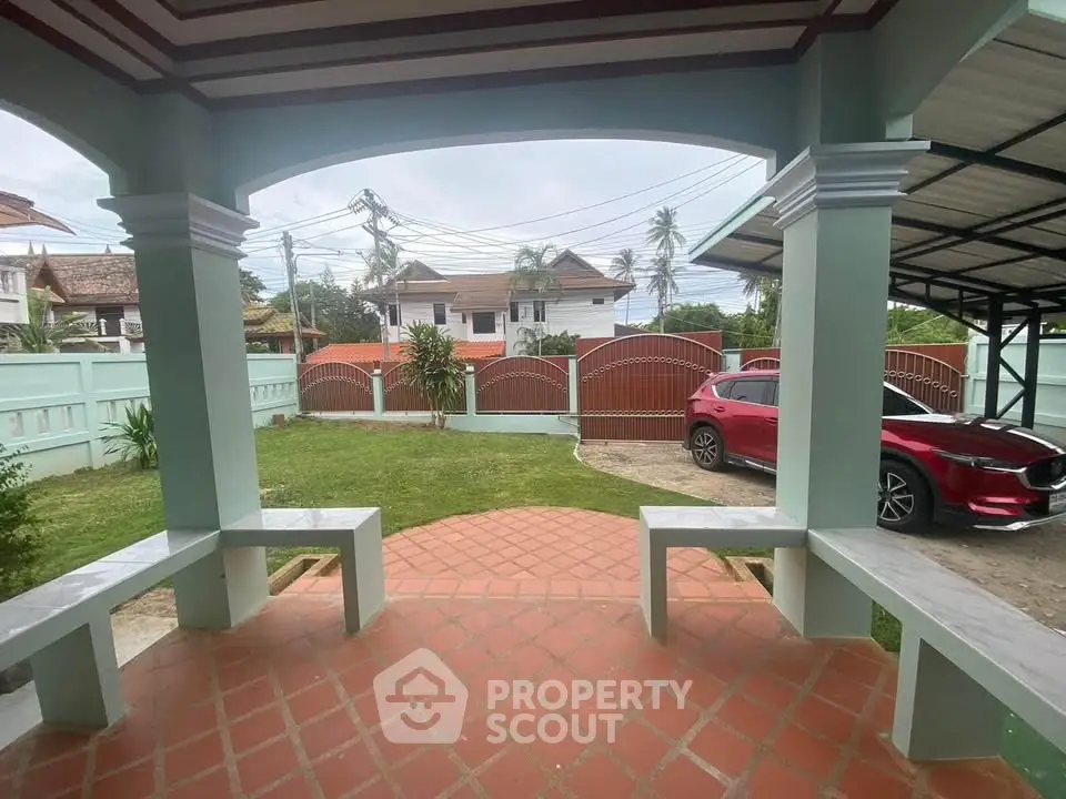 Charming home exterior with spacious driveway and lush garden, perfect for family living.