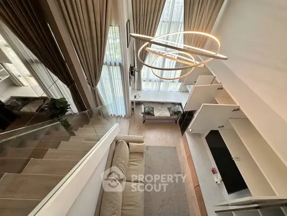 Stunning modern living room with high ceilings and elegant lighting in a luxurious apartment.