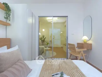 Modern bedroom with cozy decor and sliding glass doors leading to a stylish living area.