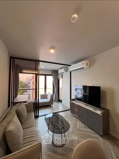 Modern living room with stylish furniture and large windows offering a scenic view.