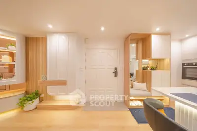 Modern open-plan living space with stylish decor and built-in storage solutions.