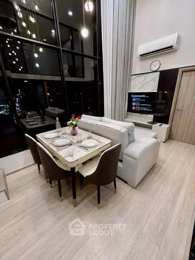 Luxurious modern living room with high ceilings and elegant dining area