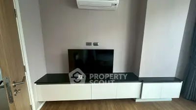Modern living room with sleek TV unit and air conditioning, perfect for contemporary living.