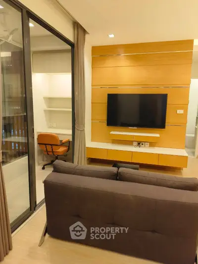 Modern living room with wall-mounted TV and cozy seating area