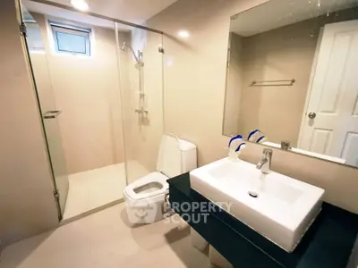 Modern bathroom with glass shower and sleek fixtures