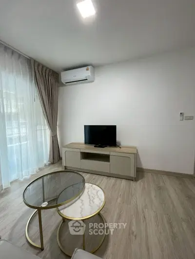 Modern living room with sleek TV stand and stylish coffee tables