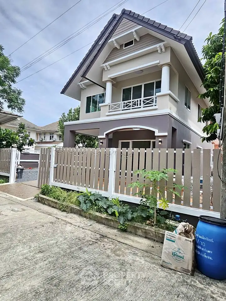 Charming two-story house with modern design and fenced yard in a serene neighborhood.