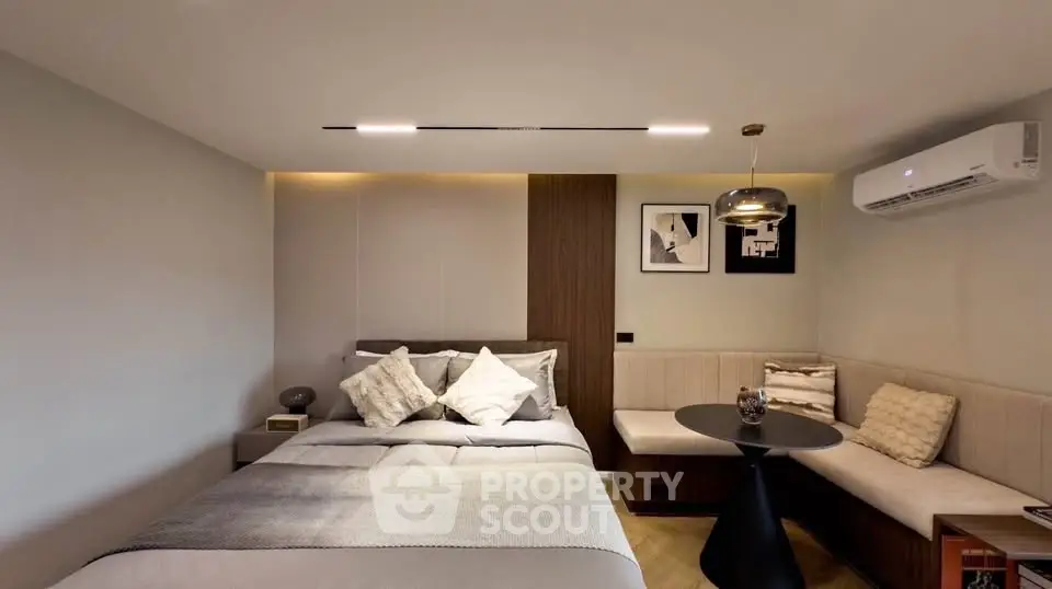 Modern bedroom with cozy seating area and elegant decor