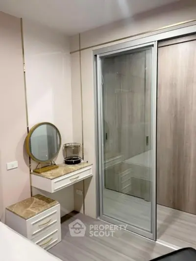 Modern bedroom with stylish vanity and sliding closet doors