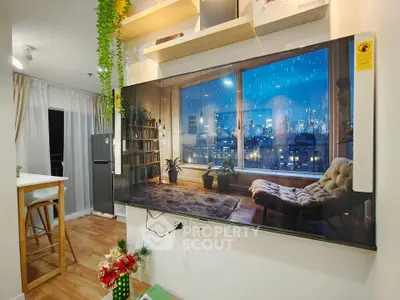 Modern living room with large TV, cozy decor, and city view, perfect for urban living.
