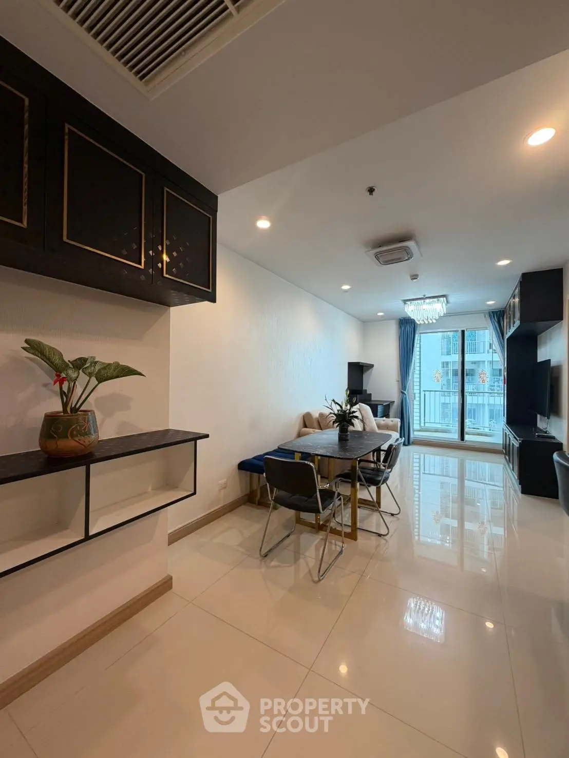 Modern living room with elegant decor and large windows offering city views
