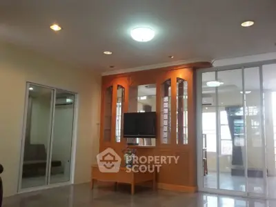 Spacious living room with modern lighting and built-in TV cabinet