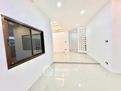 Spacious modern interior with sleek design and glossy floors, perfect for contemporary living.