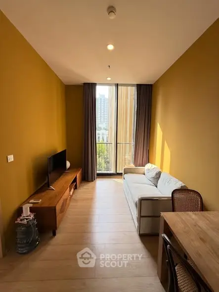 Modern living room with stylish furniture and large window view