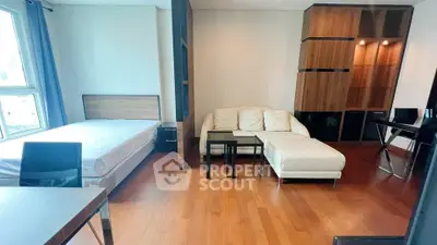Modern studio apartment with wooden flooring and stylish furniture