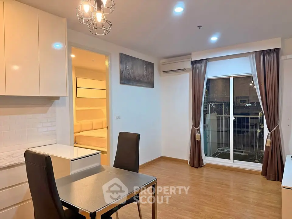 Modern apartment interior with dining area and view into cozy bedroom