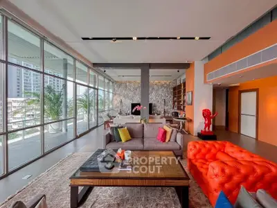Luxurious modern living room with vibrant decor and expansive balcony view