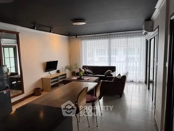 Spacious living room with modern furniture and large windows for natural light.