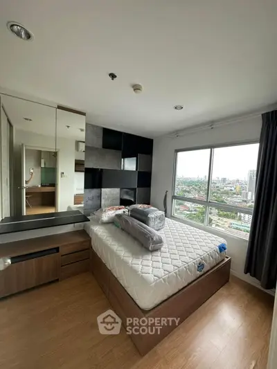 Modern bedroom with city view, featuring stylish decor and ample natural light.