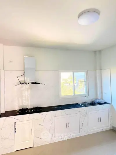 Modern kitchen with sleek marble countertops and gas stove