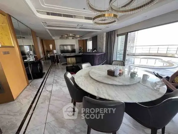 Luxurious open-plan living room with elegant dining area and stunning balcony view.