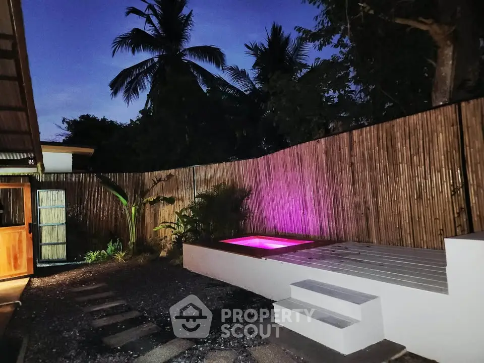 Charming outdoor area with a cozy pool and ambient lighting, perfect for relaxation and entertaining.