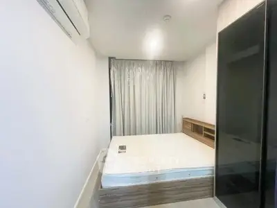 Modern minimalist bedroom with sleek design and ample natural light