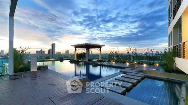 Luxurious rooftop pool with stunning city skyline views at sunset.
