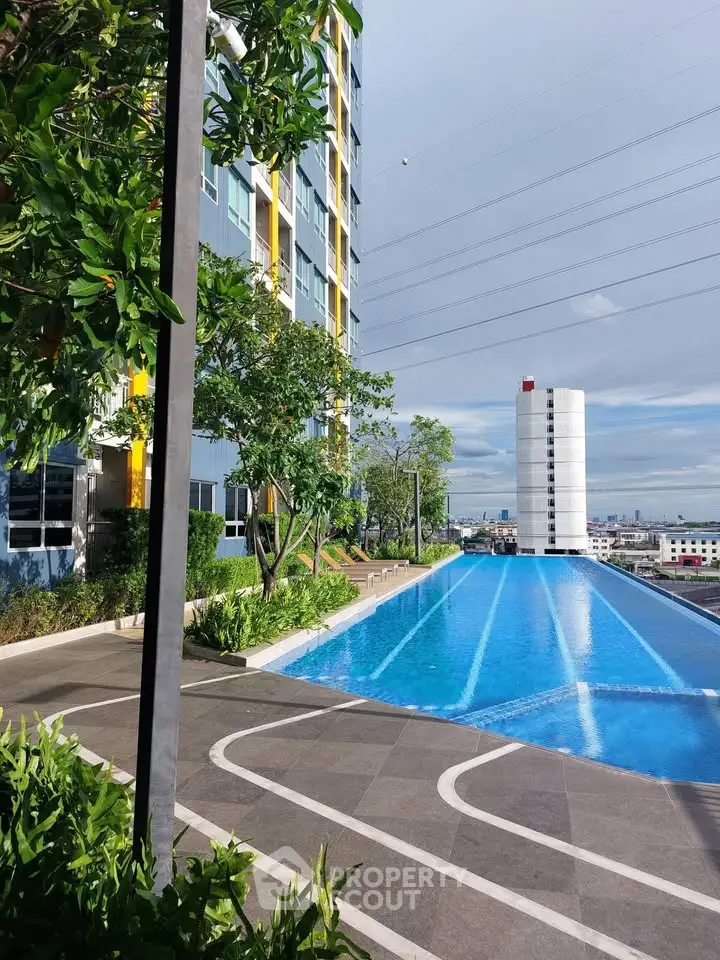 Stunning rooftop infinity pool with cityscape views and lush greenery in modern high-rise building.