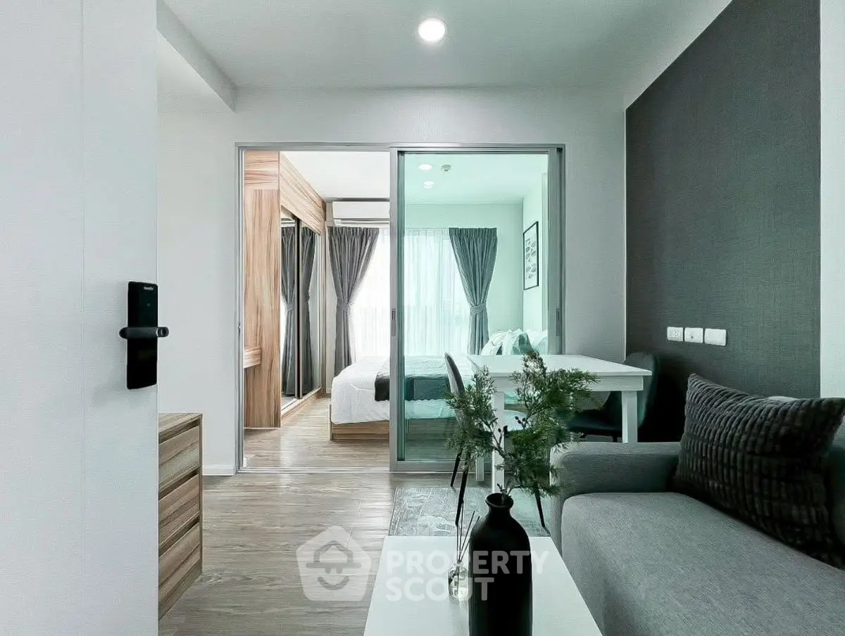 Modern apartment interior with stylish living room and cozy bedroom view.